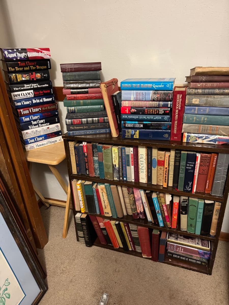Shelves packed with hardcover books at a Salem area estate sale